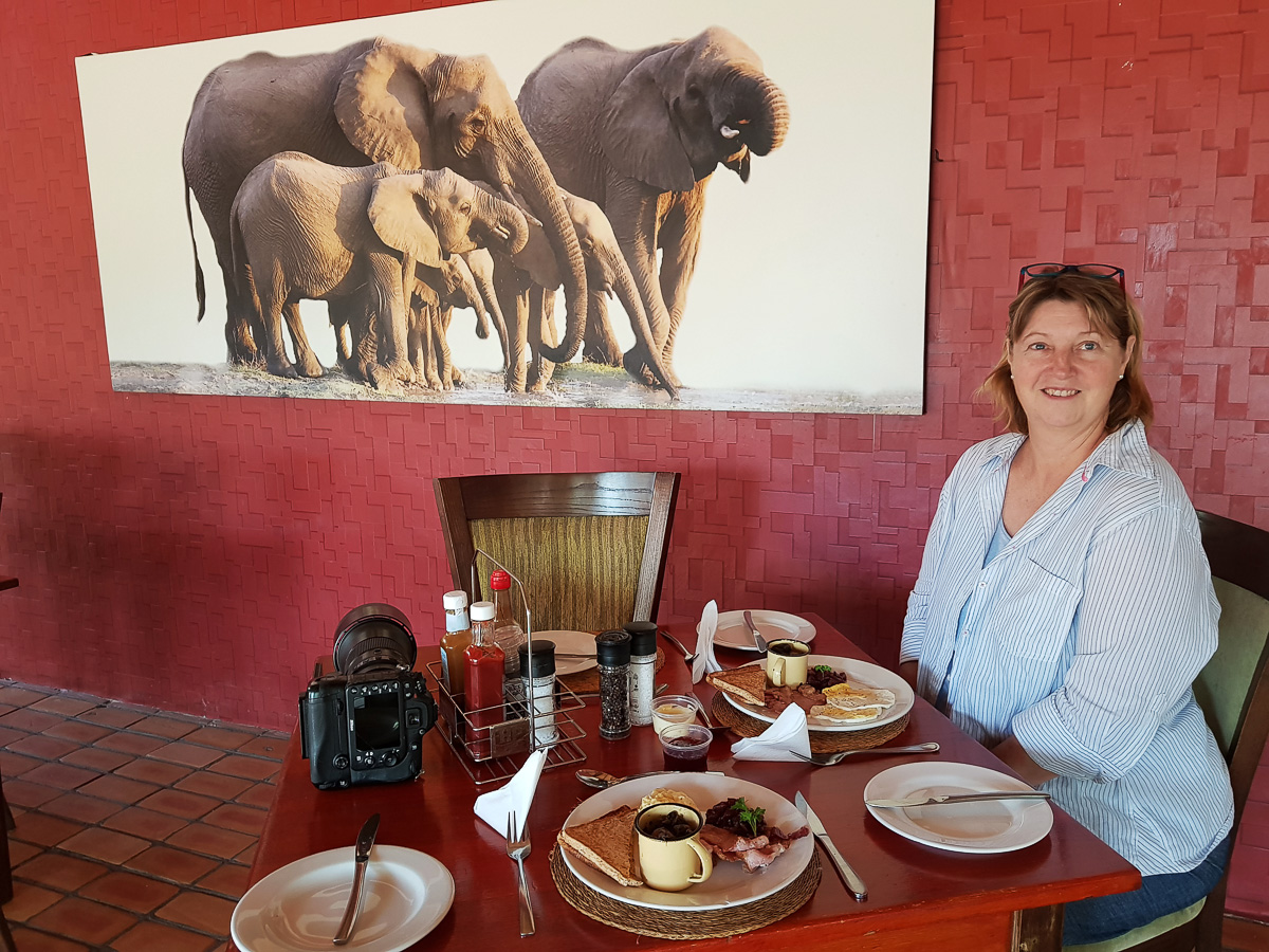 Jenny sitting in the restaurant with breakfast at Berg en Dal camp in the Kruger National Park