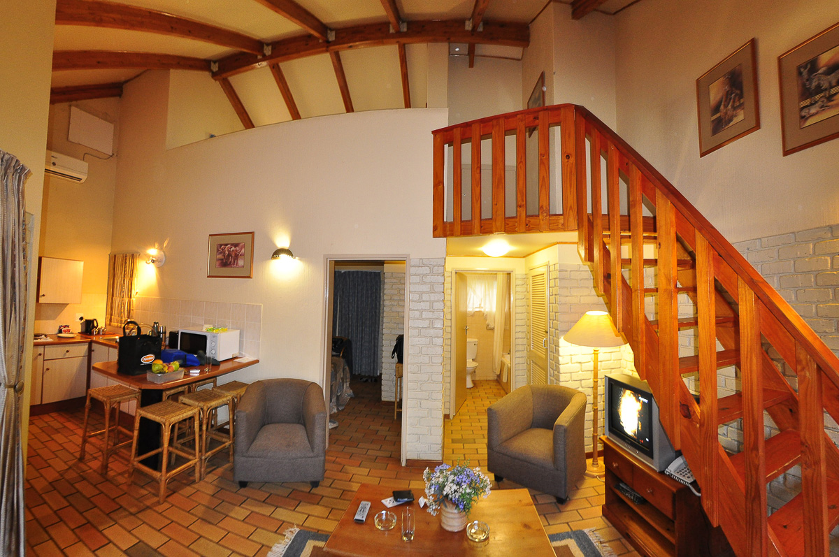 Inside Bakgatla chalet with stairs to loft