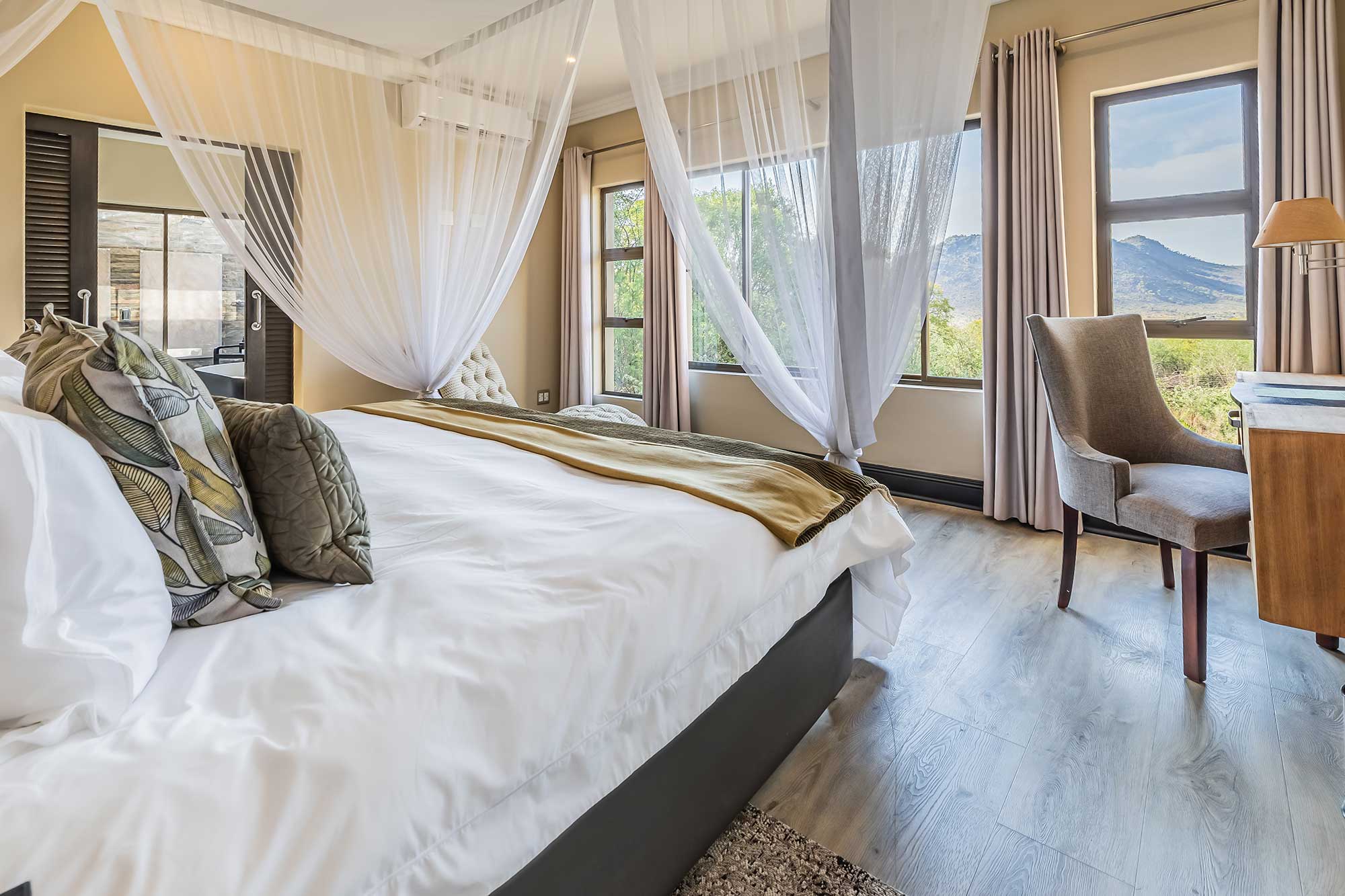 Executive suite bedroom at Shepherds Tree Game Lodge