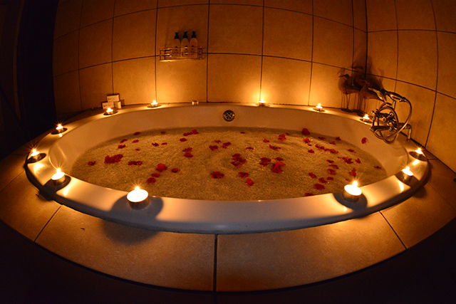 bath surrounded with candles and petals on the foam bath surrounded with candles and petals on the foam