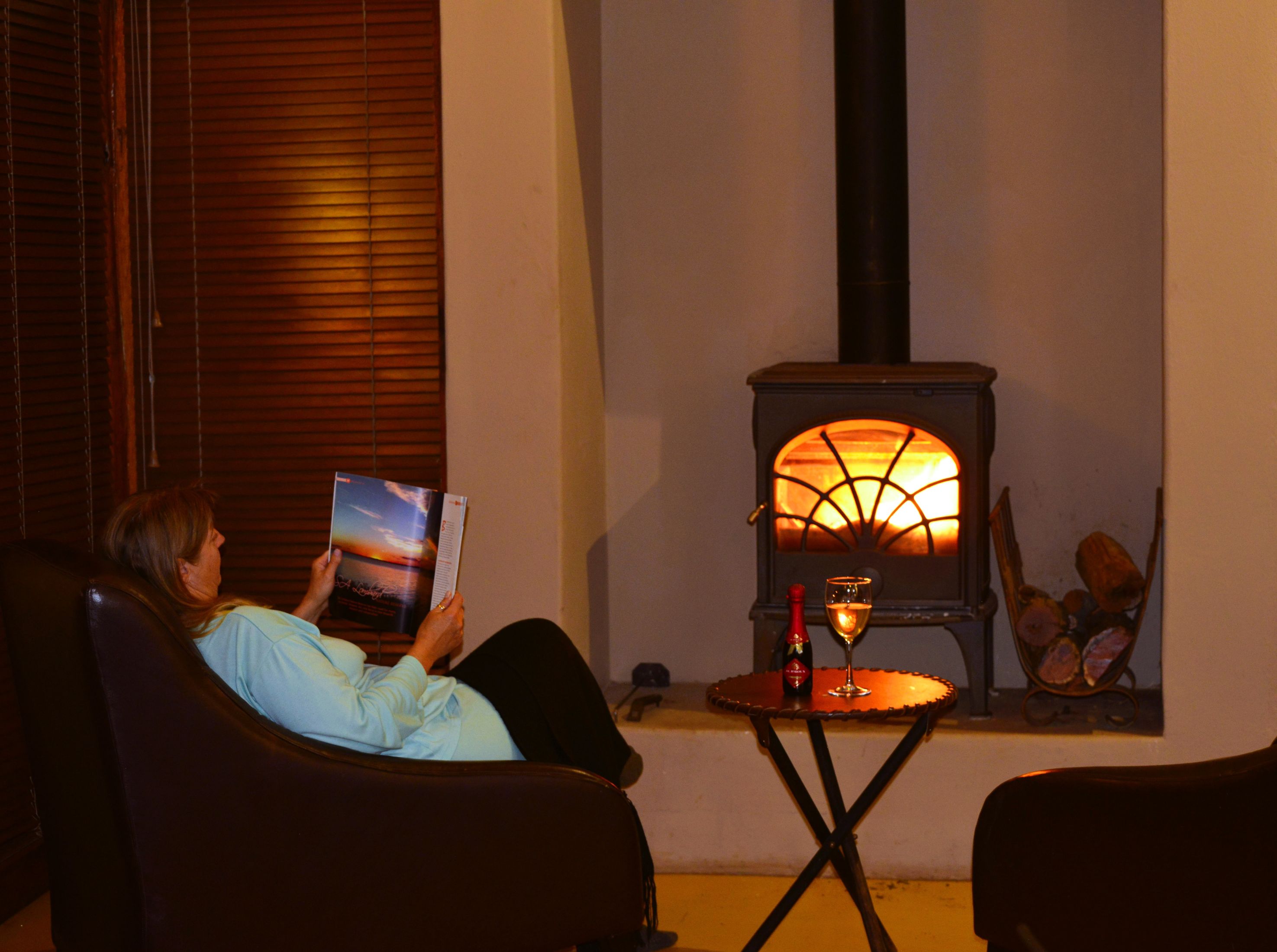 Jen sitting by the fireplace at Etali Safari Lodge
