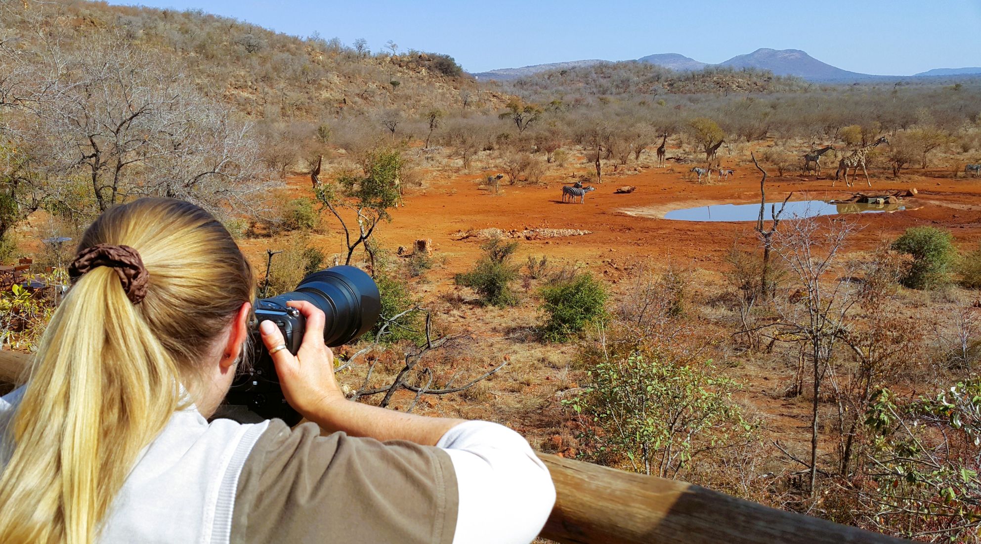 Jen photographing the animals at the Etali Safari Lodge waterhole