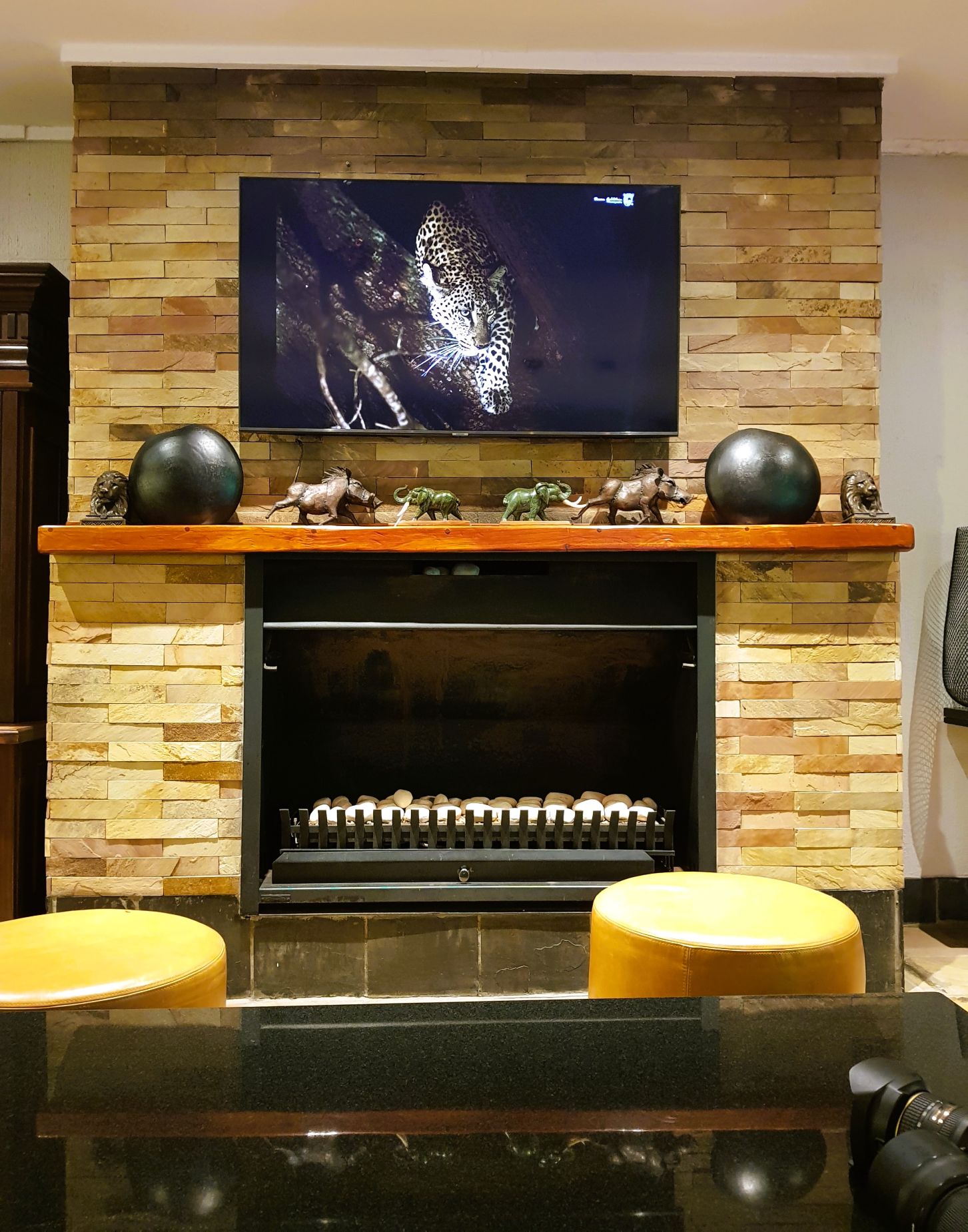 Kruger Gate Hotels TV above the Fireplace in the Lounge