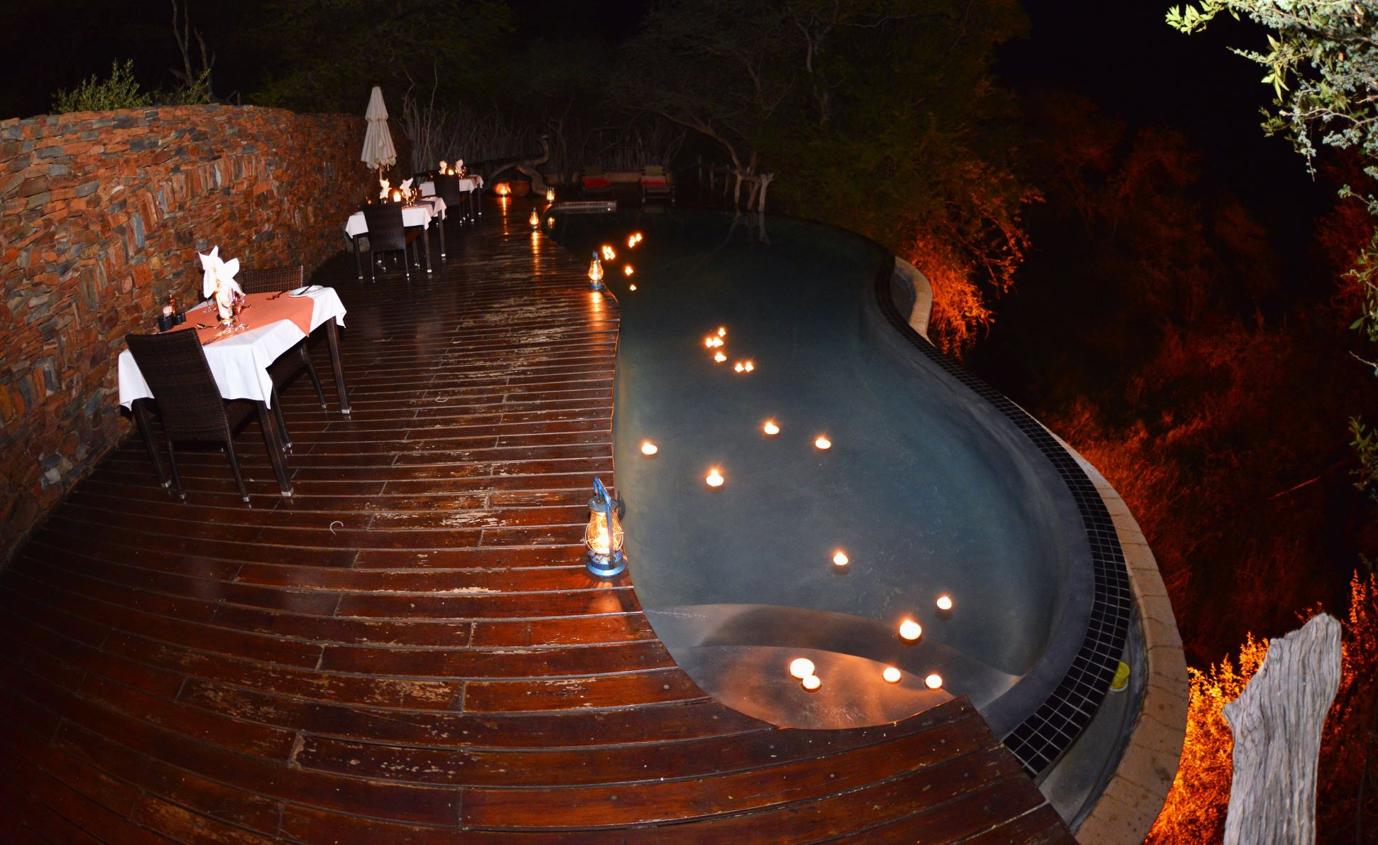 Makanyane swimming pool at night with floating candles
