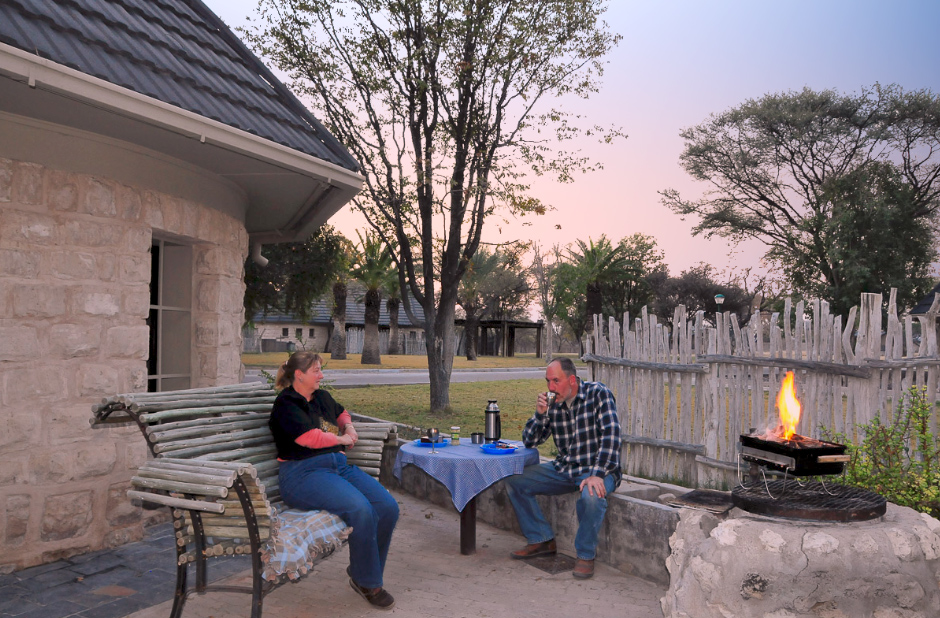 Us braaing at our OKaukuejo chalet