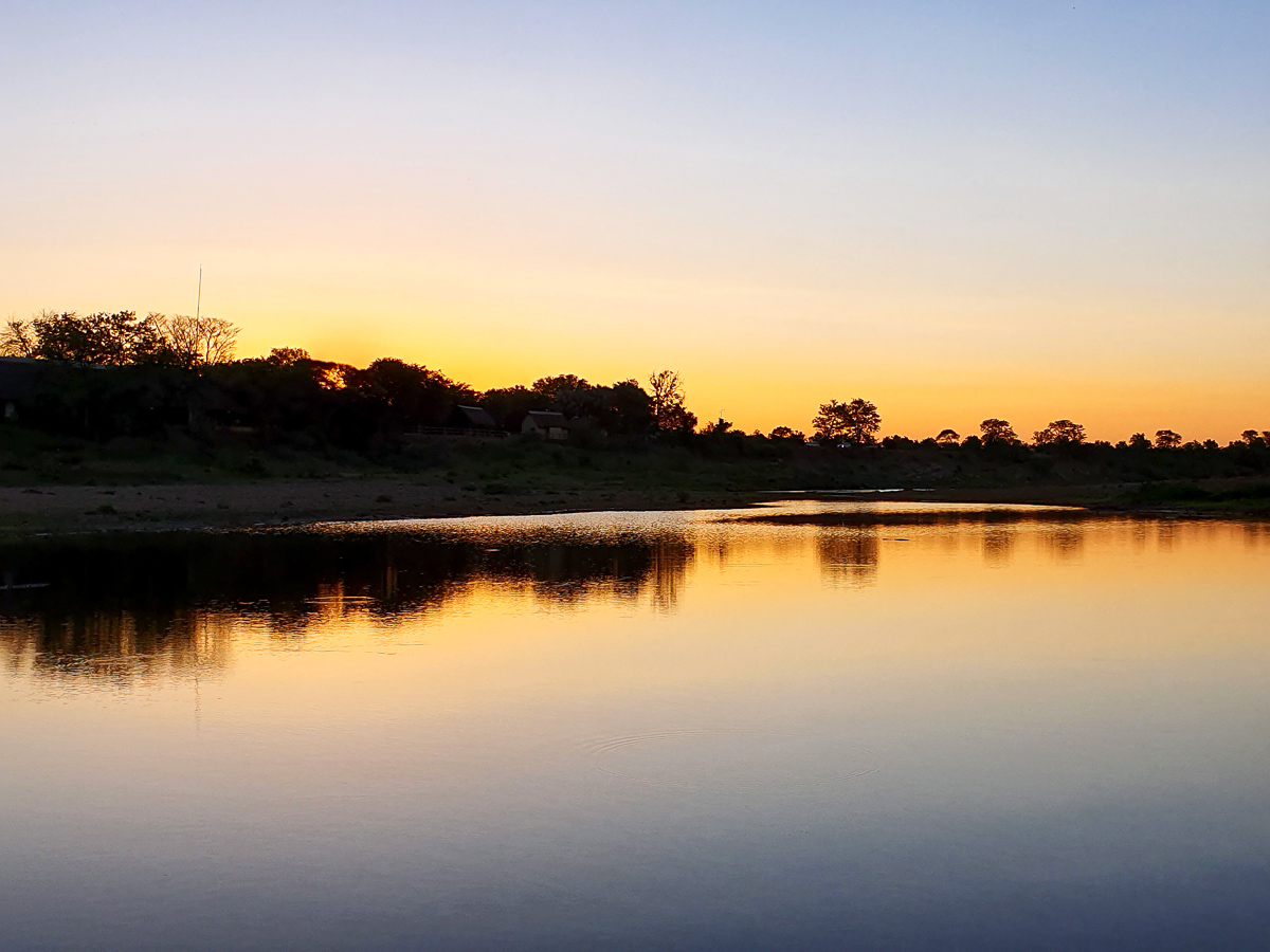 View of Shingwedzi camp from low level bridge at sunset