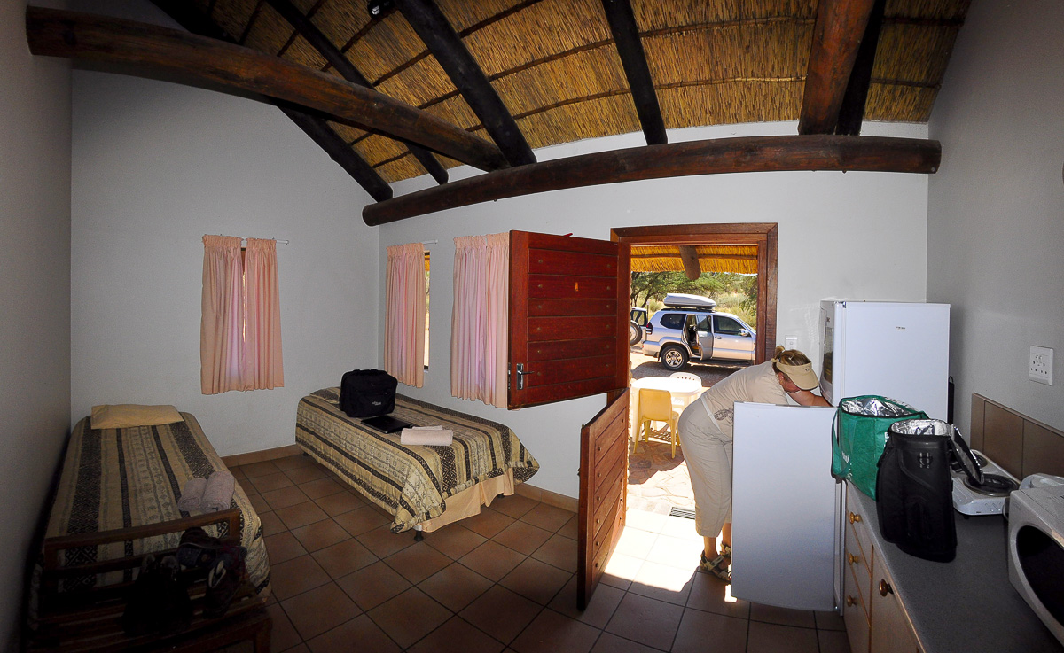 Kitchen and two Beds in chalet at Twee Rivieren camp