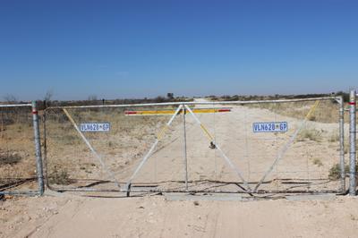 Farm gate on the road to Vanzylsrus. You lose your number plate if it gets stuck to the gate.