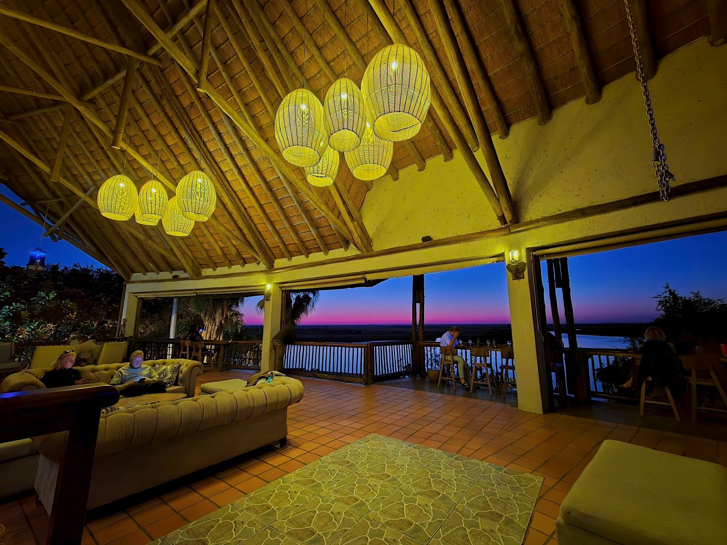 Lounge and Savuti bar overlooking the Chobe River at Sunset at Cresta Mowana