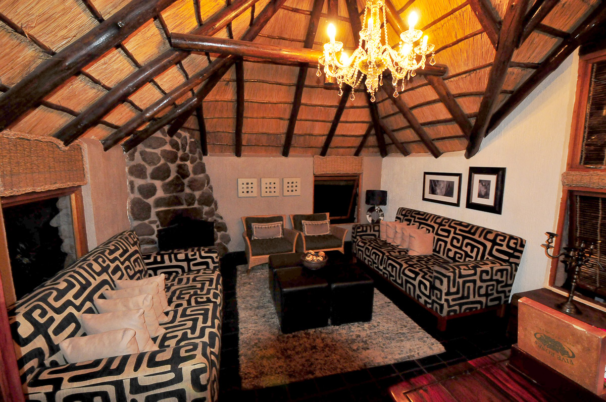 indoor lounge with fireplace at Tshukudu